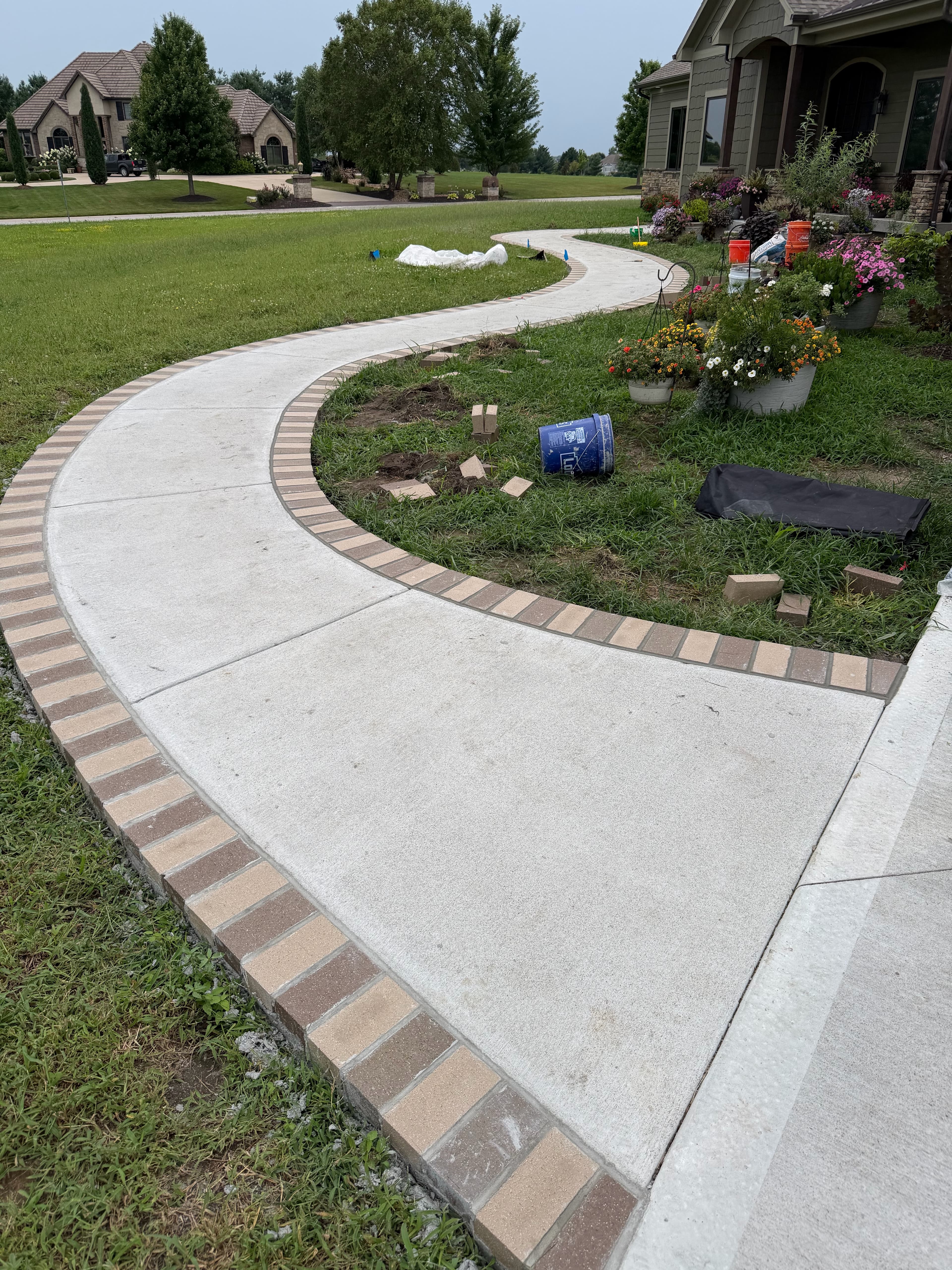 Brick-bordered concrete walkway