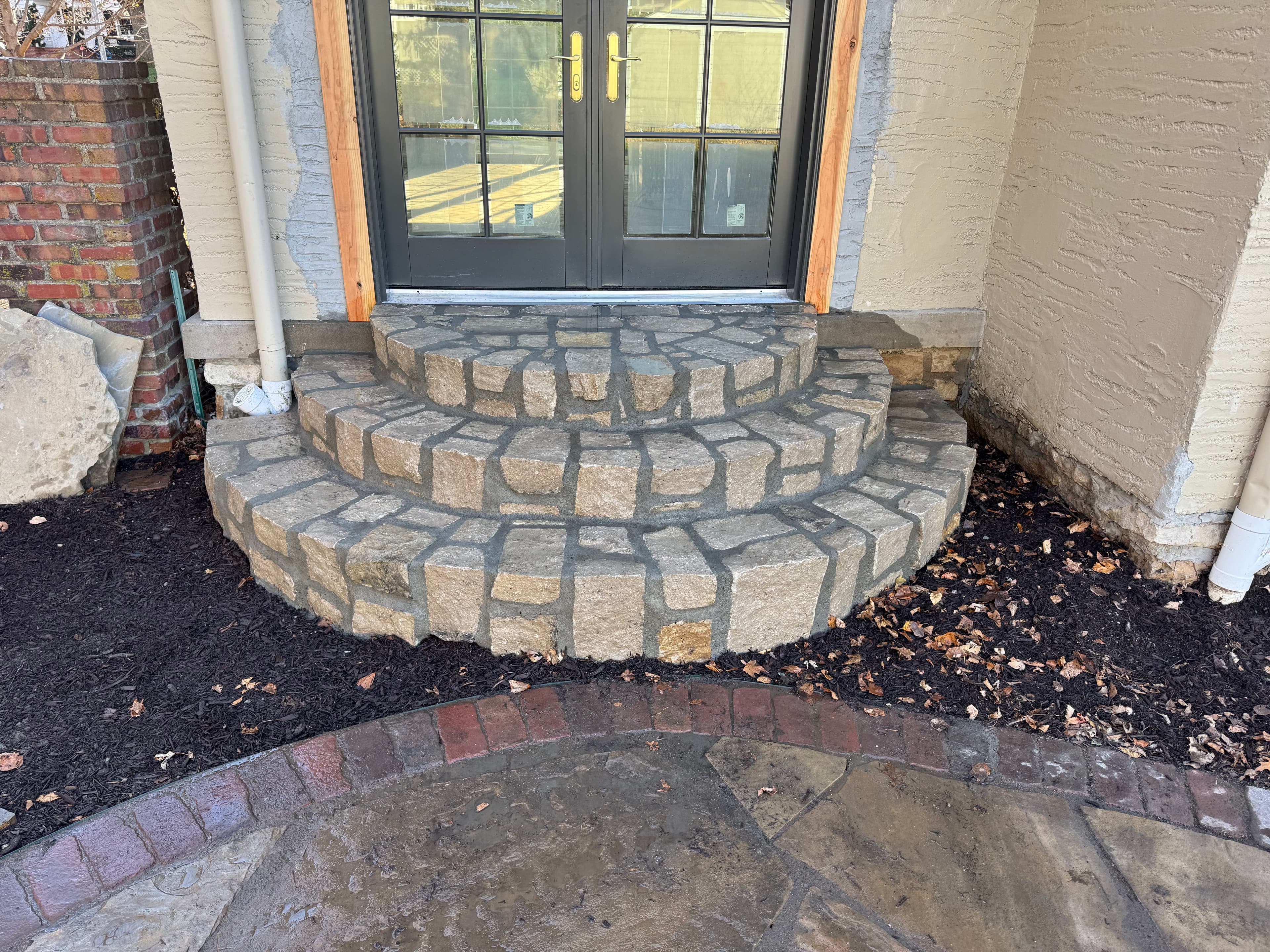 Curved stone entry steps (French doors)