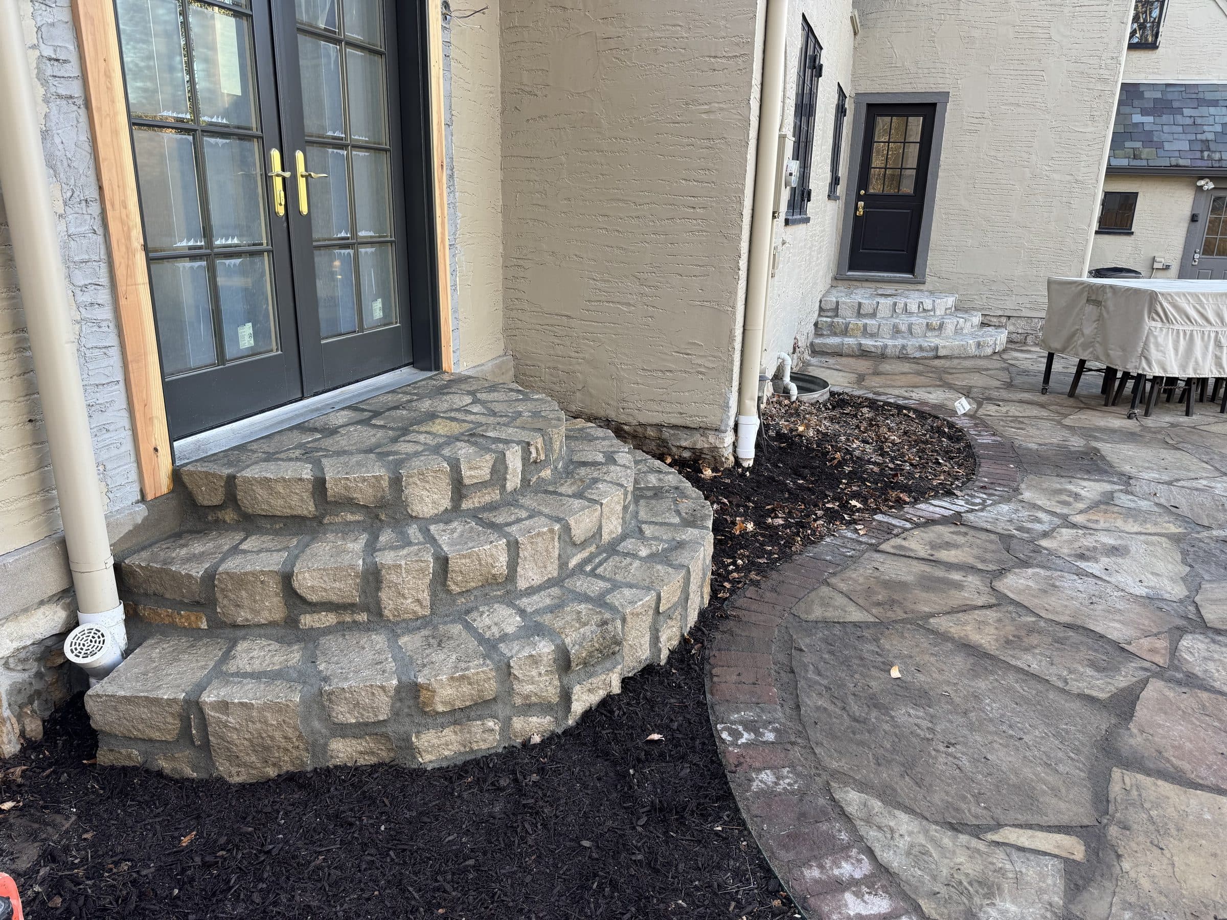 Flagstone patio and twin stone stair sets