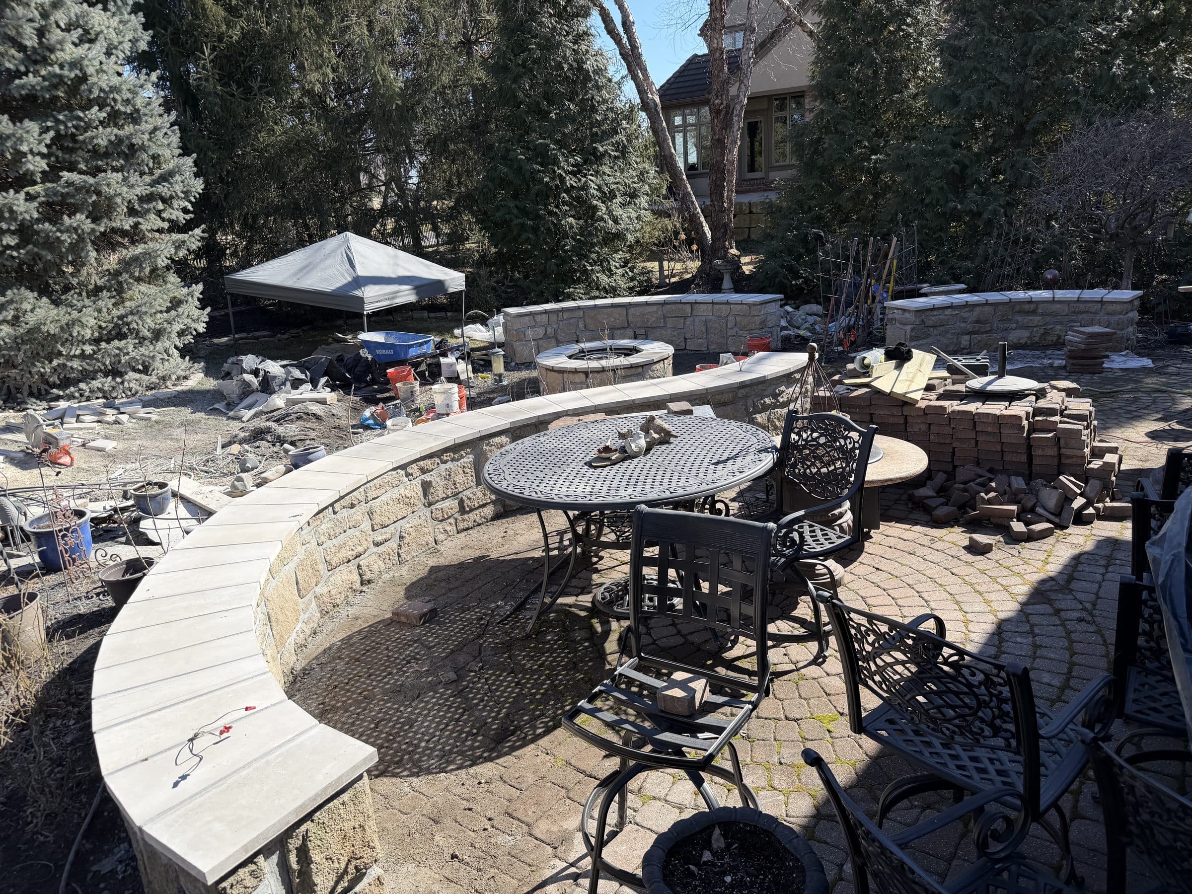 Stone seating wall + patio (in progress)