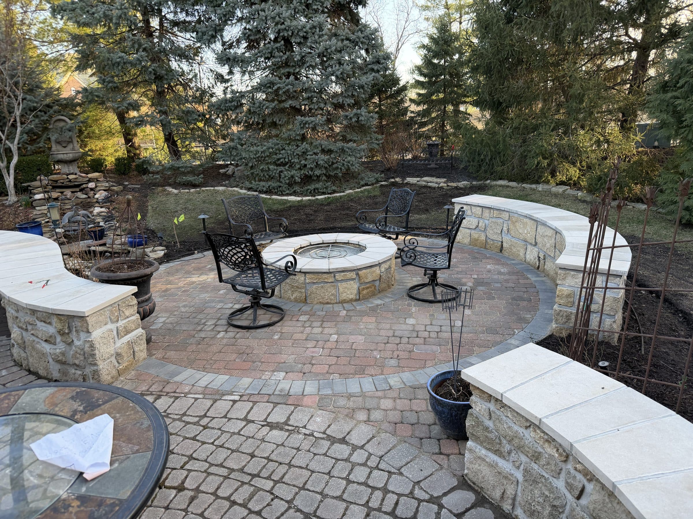 Finished fire pit with curved stone seating walls
