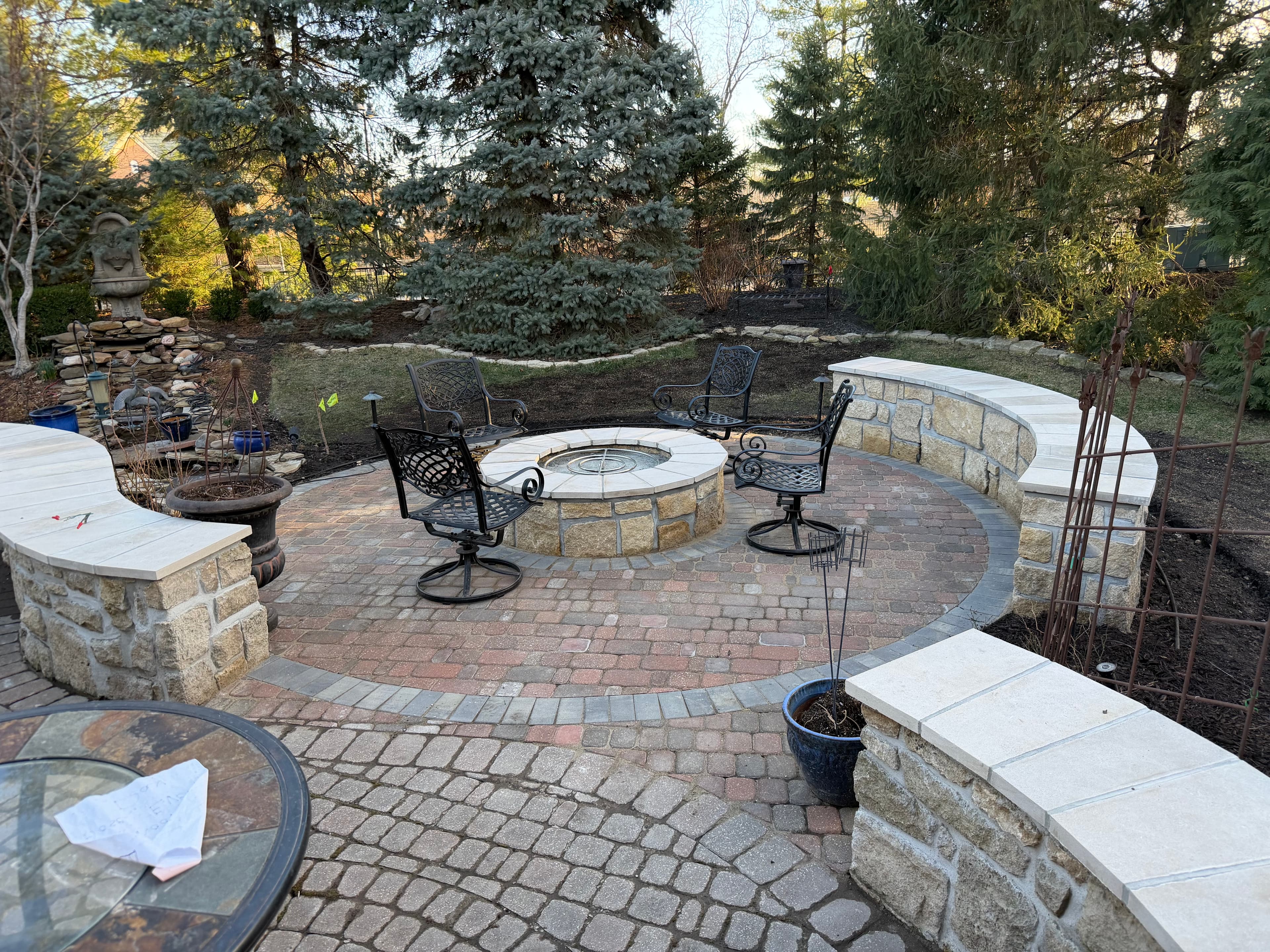 Finished fire pit with curved stone seating walls