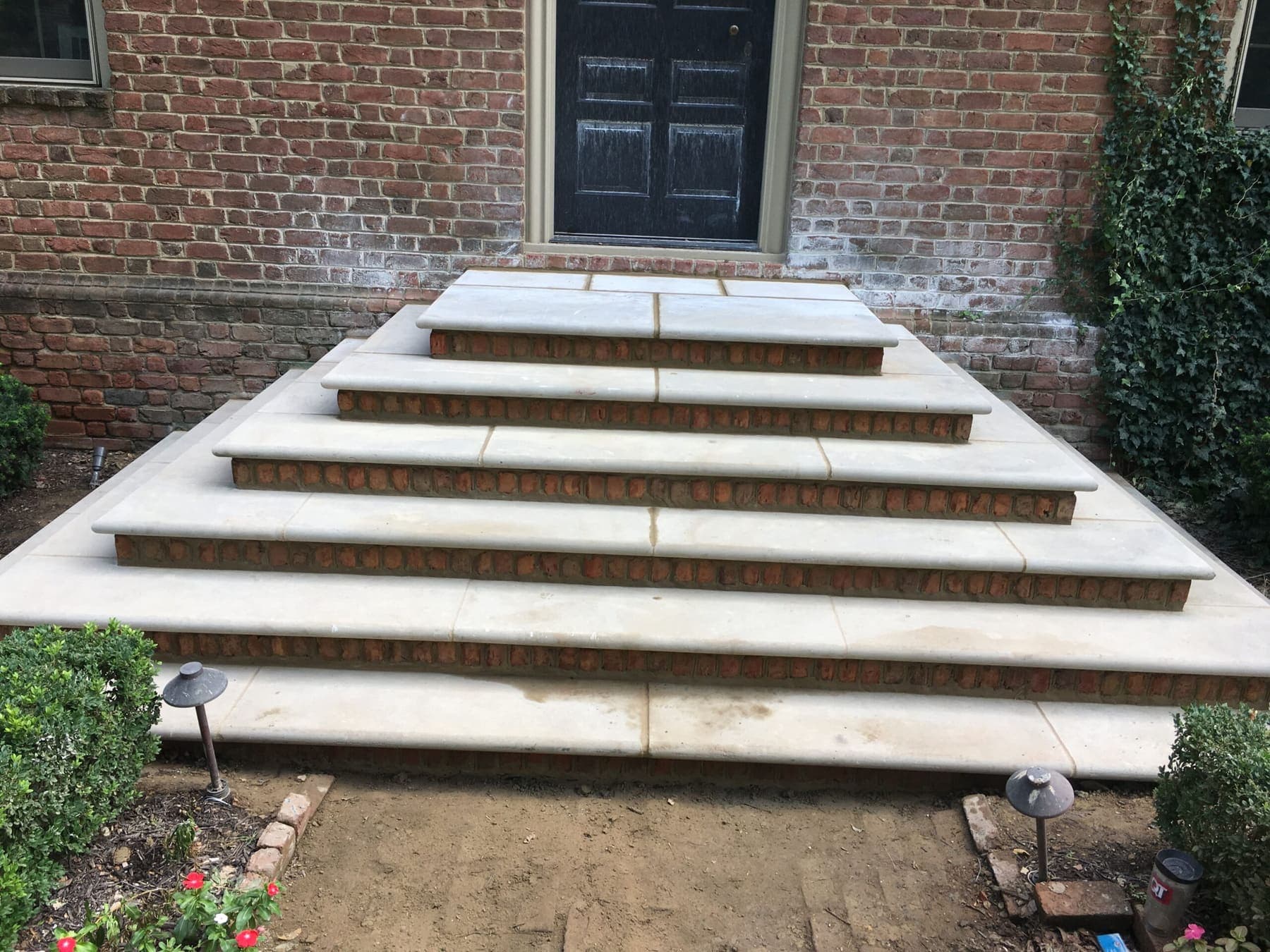 Rebuilt entry steps with stone treads and brick risers